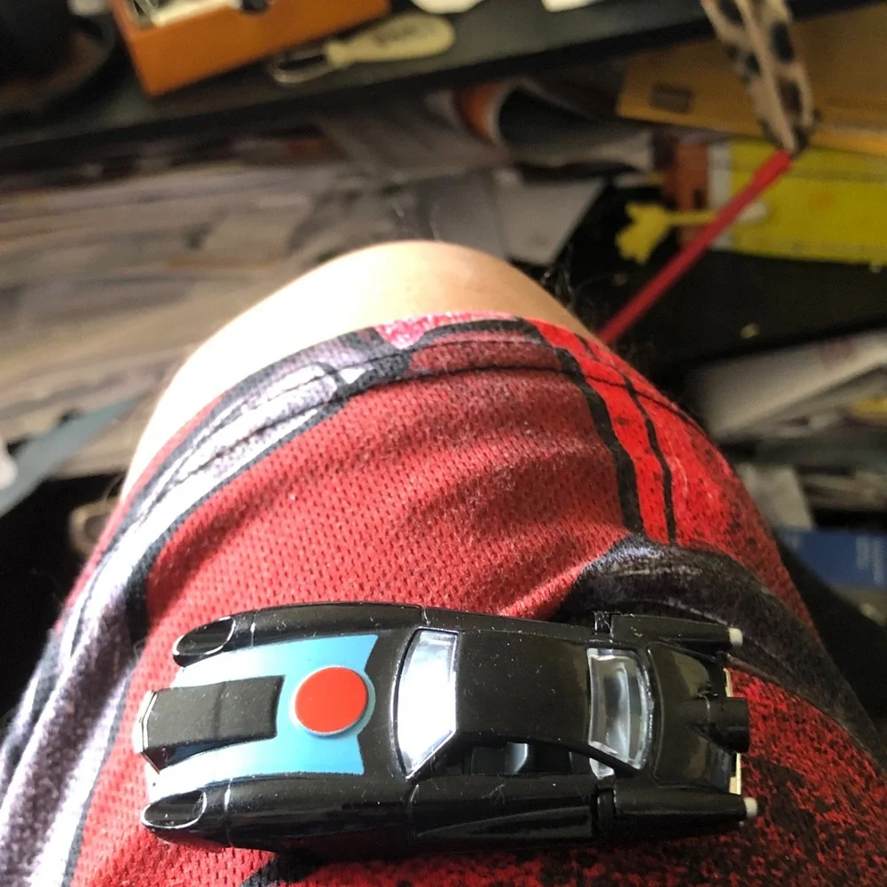 Black Toy Sports Car with Blue Hood and Red Dot